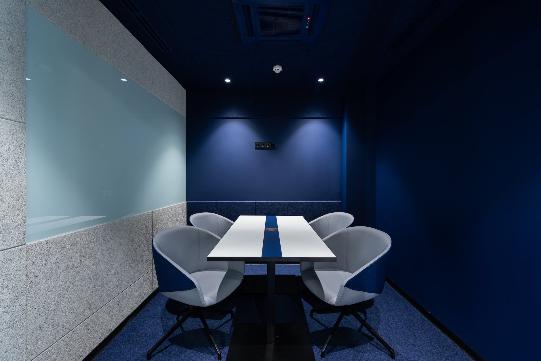 contemporary workspace with blue seats and table