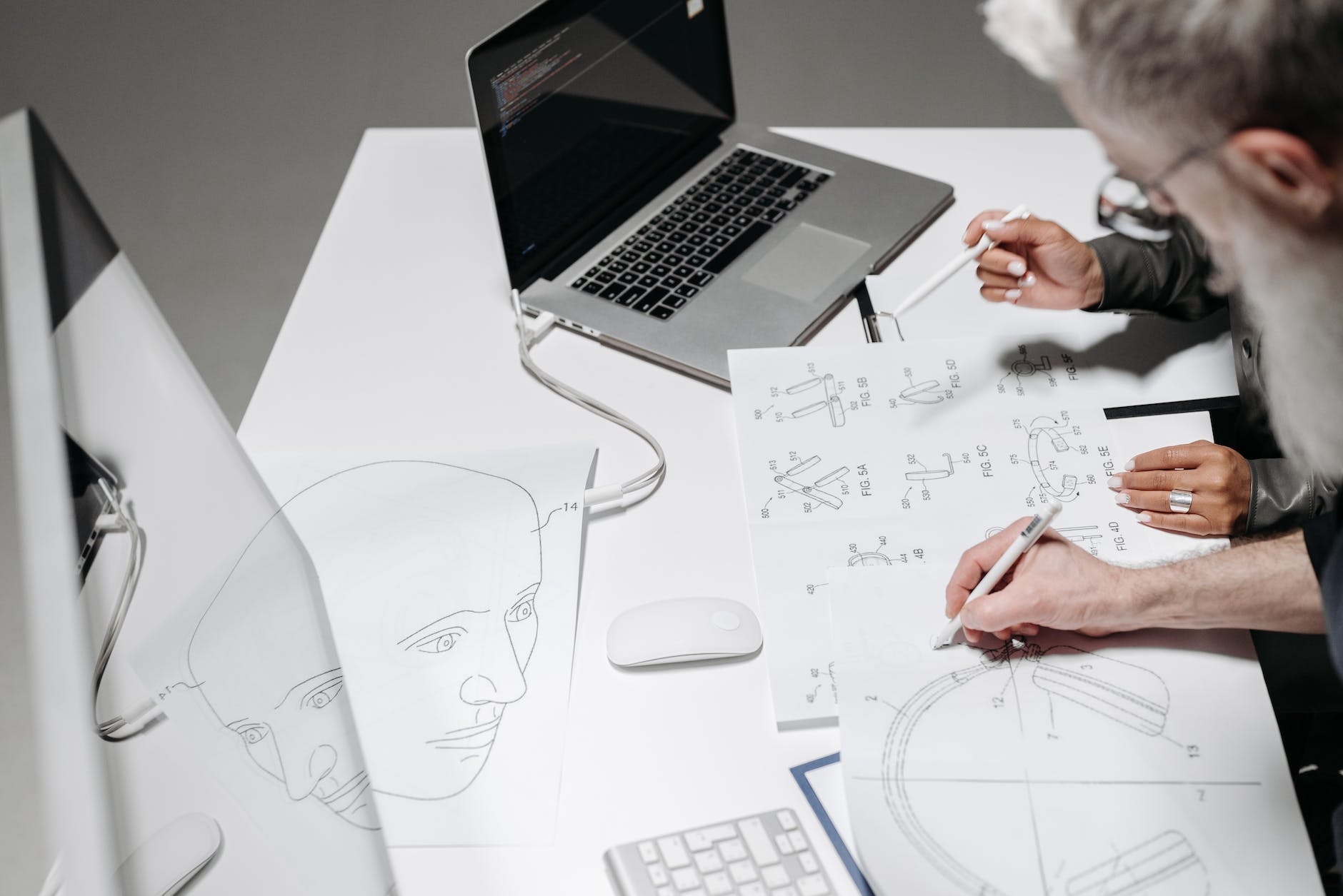 people drawing designs on papers