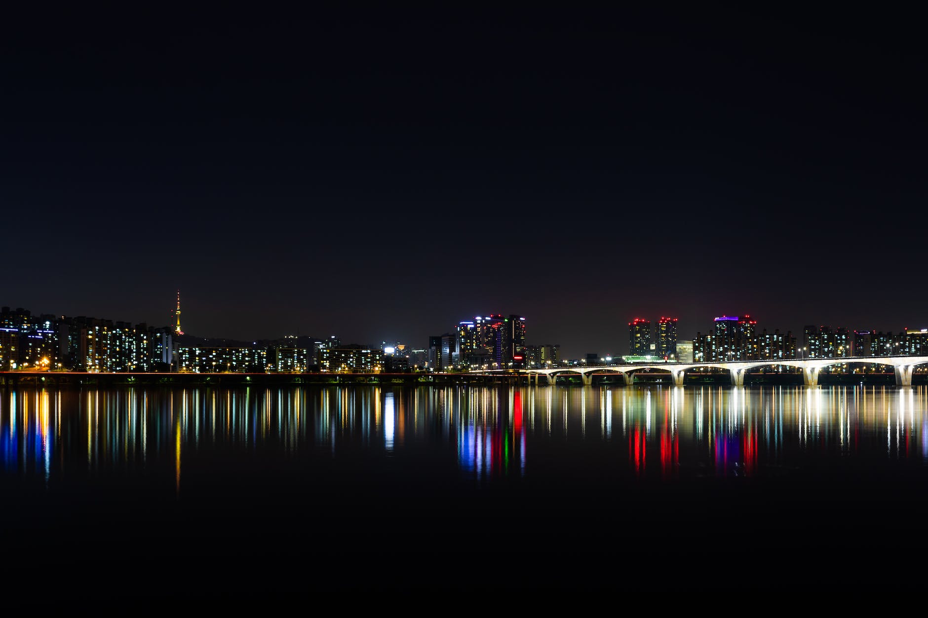 city near body of water during night time