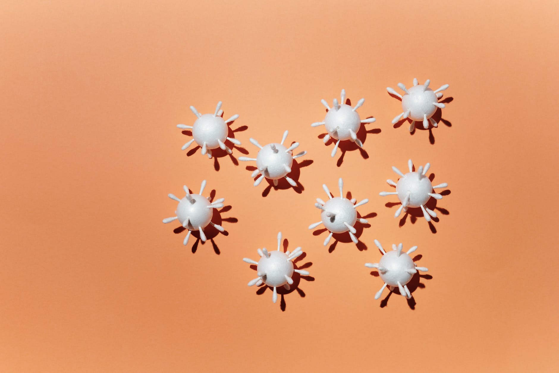 coronavirus scale model on peach background