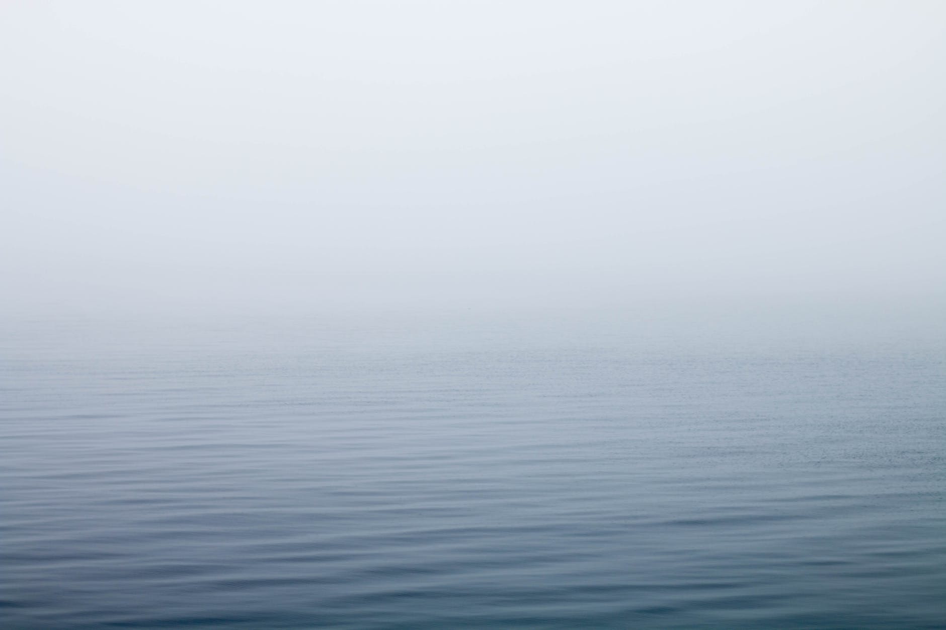 body of water under fog